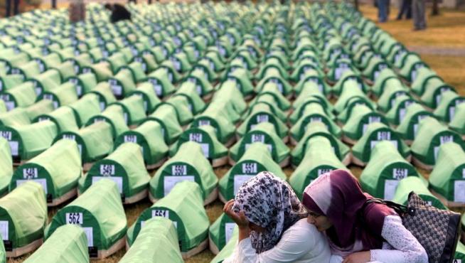 Dos mujeres se lamentan junto a los féretros de la matanza de Srebrenica