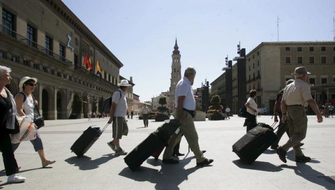 Un grupo de turistas camina por la plaza del Pilar de Zaragoza