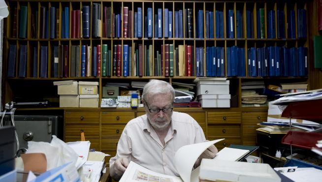 Manuel Duplá, dueño de la última filatelia de Aragón, revisa unos sellos en su despacho.