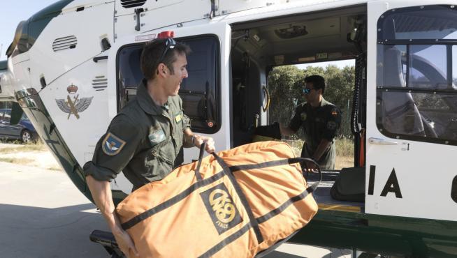 Especialistas de la Unidad Aérea colocando la camilla en el helicóptero con base en Huesca