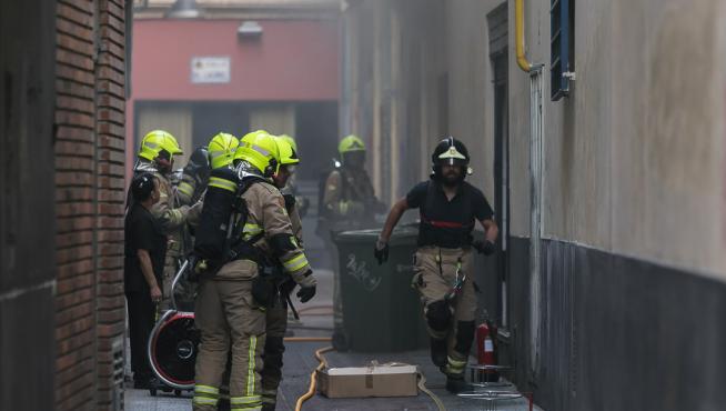 Los bomberos han accedido a la cocina del restaurante por la puerta trasera.