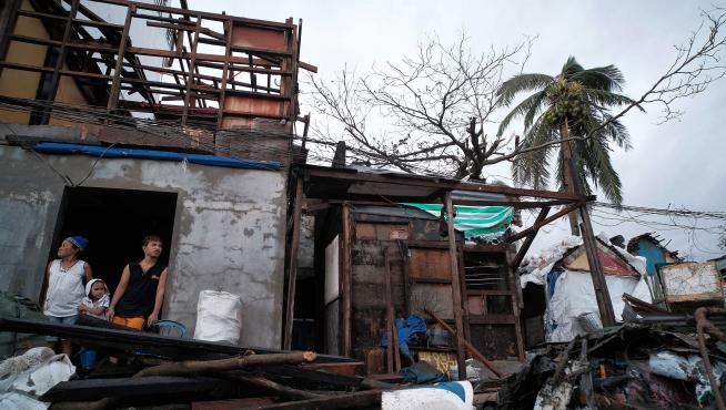 Legazpi City (Philippines), 03/12/2019.- Villagers look on from inside a damaged house in the aftermath of Typhoon Kammuri, in Legazpi city, Philippines, 03 December 2019. Typhoon Kammuri made landfall on 02 December and forced the closure of Ninoy Aquino International Airport in Manila. The typhoon also affected the ongoing Southeast Asian Games. According to the event organizers, several sporting events have been rescheduled or cancelled. (Filipinas) EFE/EPA/ZALRIAN SAYAT Aftermath of Typhoon Kammuri in the Philippines