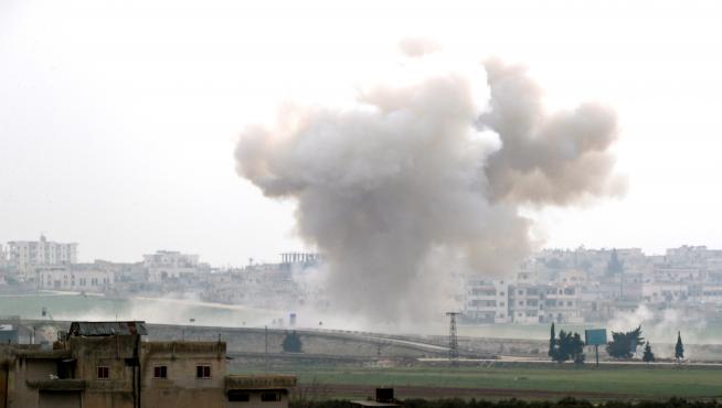 Smoke rises after an air strike in Saraqeb in Idlib province