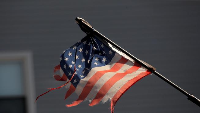 Tattered American flag flies across the street from Wyckoff Heights Medical Center during outbreak of coronavirus disease (COVID-19) in New York