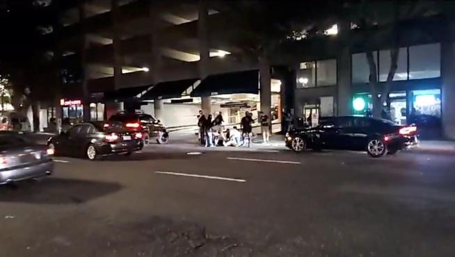 People surround a victim of a shooting in Portland, Oregon