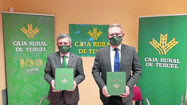 José Cuevas, presidente de Caja Rural -a la derecha-, y Ángel Espinosa muestran el libro del centenario