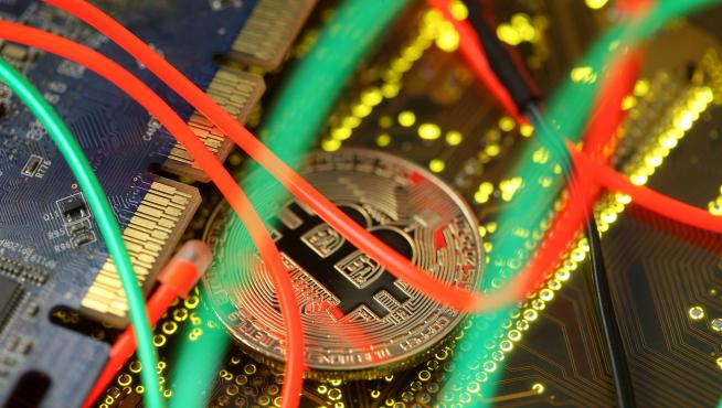 FILE PHOTO: Representation of the Bitcoin virtual currency standing on the PC motherboard is seen in this illustration picture