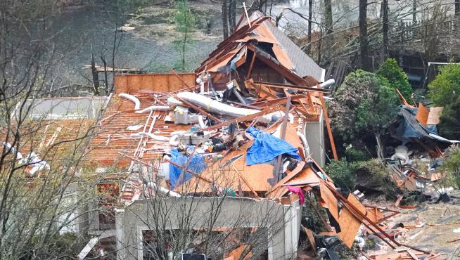 A house is left missing a roof after a tornado passed through the Eagle Point subdivision in Hoover
