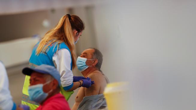Man receives an injection with AstraZeneca's COVID-19 vaccine at a vaccination centre, in Madrid