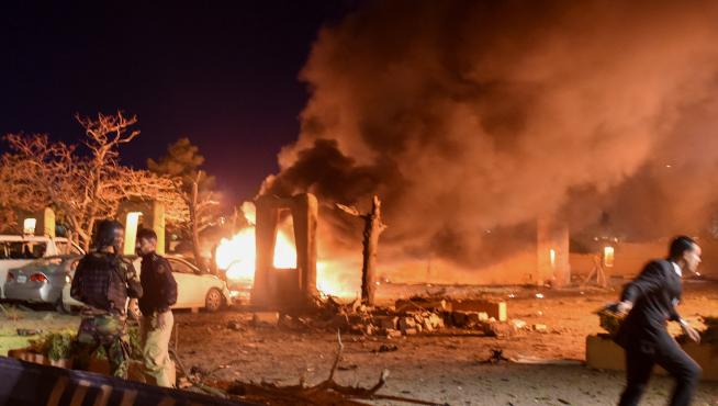 Police and a paramilitary soldier are seen after an explosion at a luxury hotel in Quetta