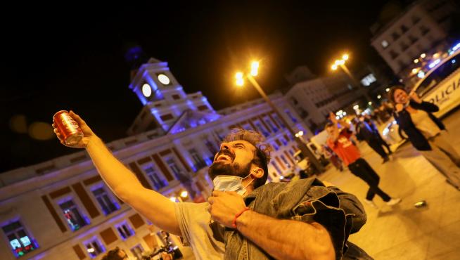 People celebrate as the state of emergency decreed by the Spanish Government to prevent the spread of the coronavirus disease (COVID-19) gets lifted in Madrid