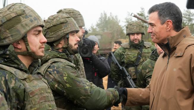 Spanish Prime Minister Pedro Sanchez interacts with members of the military following the Russian invasion of Ukraine, in the Adazi military base, Latvia, March 8, 2022. REUTERS/Ints Kalnins UKRAINE-CRISIS/TRUDEAU-LATVIA