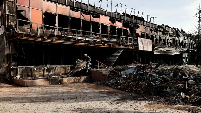 A local resident walks past a destroyed building, amid Russia's attack on Ukraine in Bakhmut