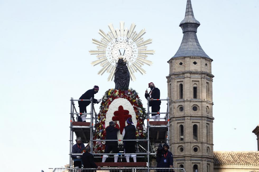 Conforme avanza la mañana el manto y la estructura de la Virgen se van cubriendo de flores. La afluencia de oferentes mantiene las distancias pero no cesa.