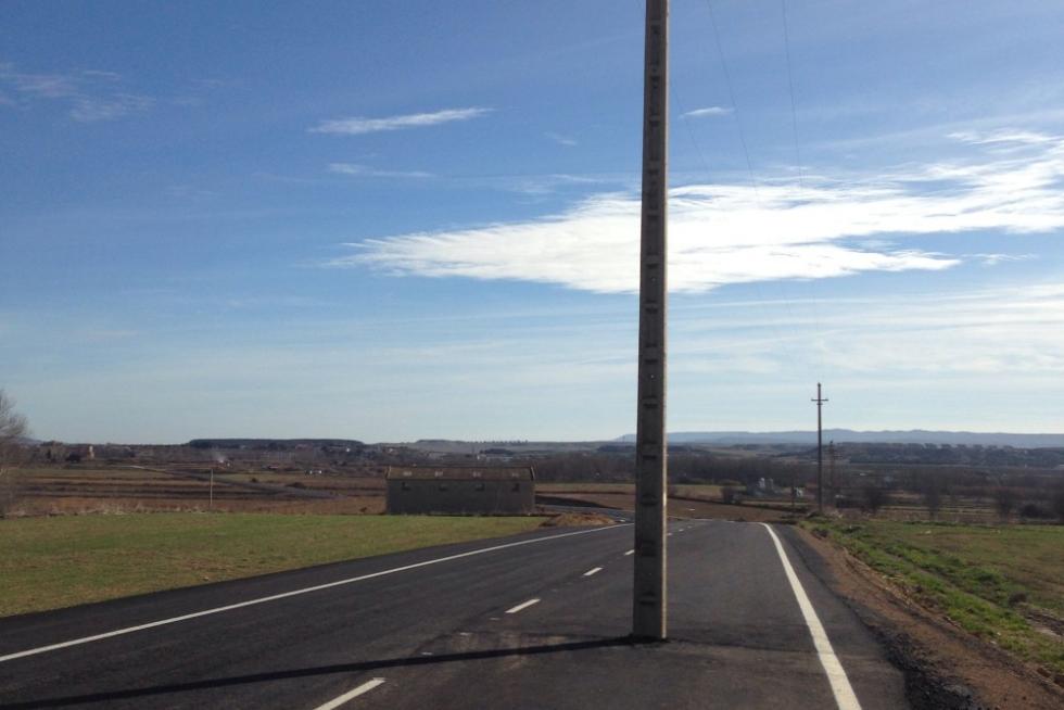 Un poste eléctrico en mitad de una carretera en Ejea