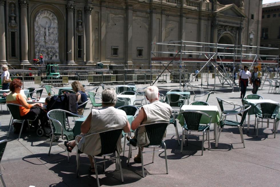 Gente en las terrazas de la plaza del Pilar observan los preparativos para los actos de conmemoración del centenario de la Coronación de la Virgen, en 2005