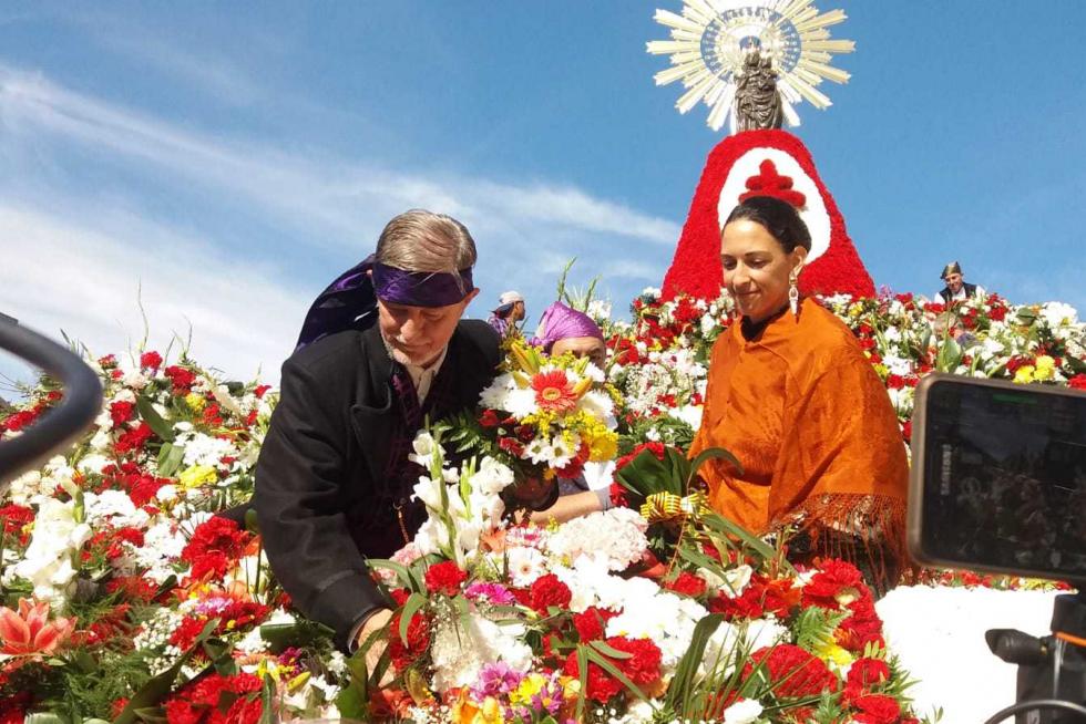 El alcalde, Pedro Santisteve, coloca las flores en el manto de la Virgen.