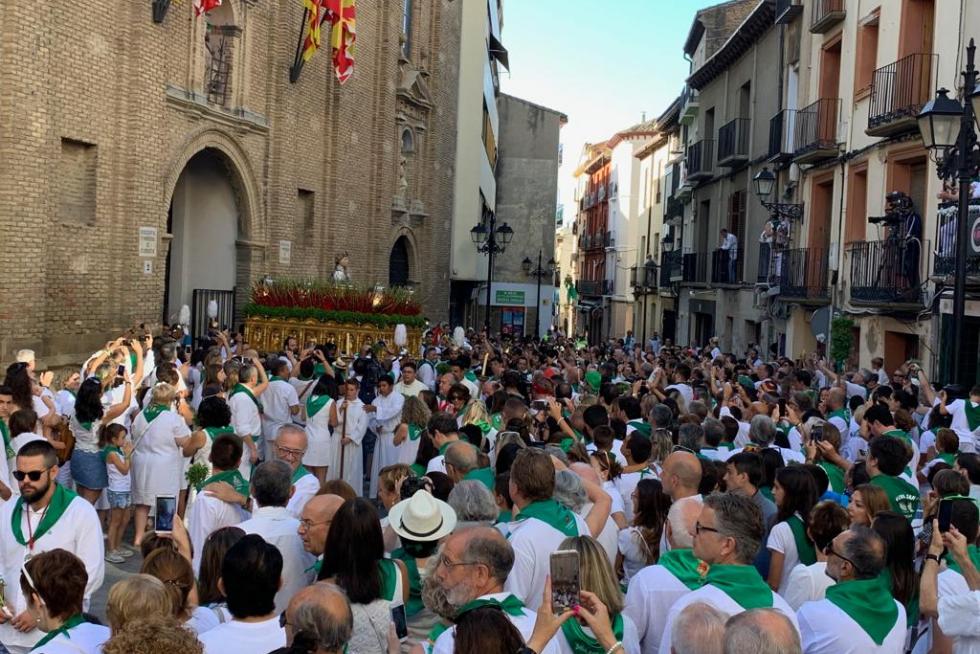 El busto de San Lorenzo ya asoma por la puerta de la basílica entre aplausos y con la música de la banda.