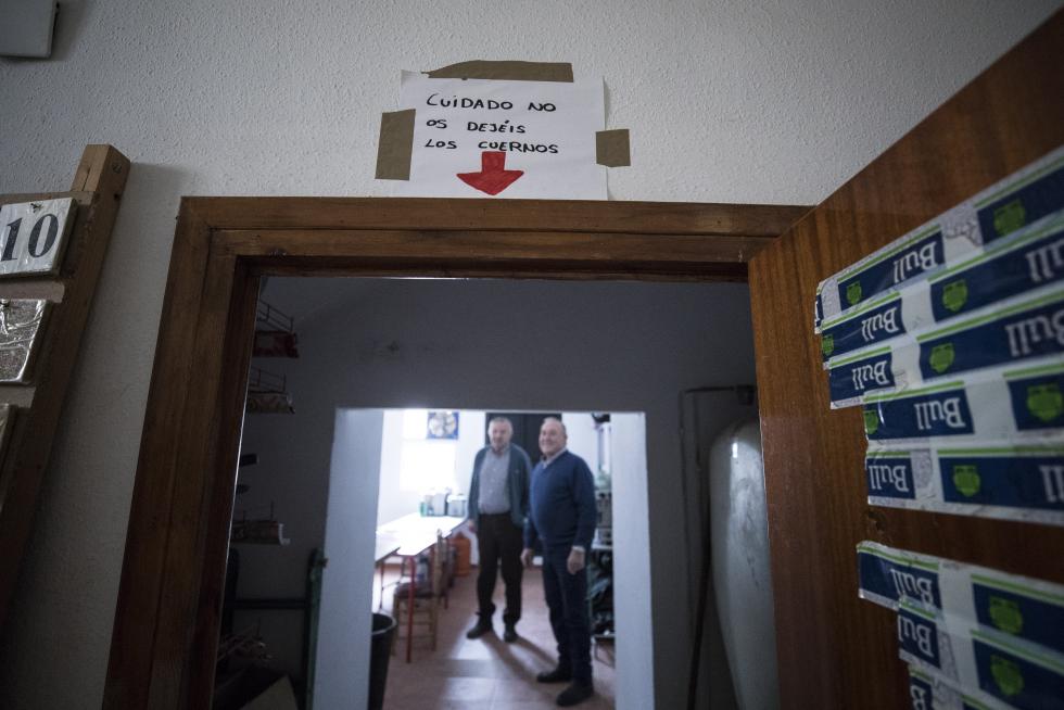 Cartel avisador en clave humorística para los que acceden a la cocina del club social por su puerta, de pequeño tamaño, en Cosa
