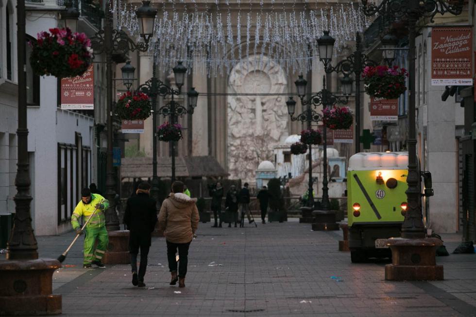 Los restos de la fiesta se dejaban ver en Zaragoza a primera hora de la mañana de este miércoles. Brigadas de limpieza y rezagados aún de fiesta coincidían en las primeras horas del día de Año Nuevo.