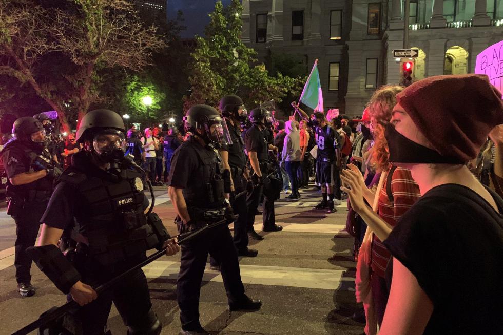 Demonstrators face off with police near Capitol building in Denver, Colorado