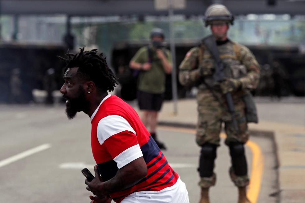 Man reacts as he confronts National Guard members guarding the area in the aftermath of a protest, in Minneapolis