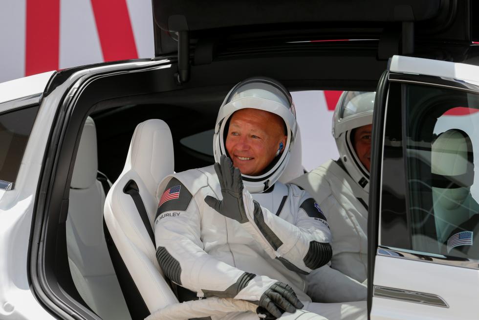 NASA astronaut Douglas Hurley waves as he heads to Pad39A before the launch of a SpaceX Falcon 9 rocket and Crew Dragon spacecraft at the Kennedy Space Center, in Cape Canavera