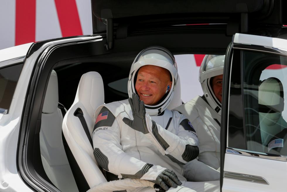 NASA astronaut Douglas Hurley waves as he heads to Pad39A before the launch of a SpaceX Falcon 9 rocket and Crew Dragon spacecraft at the Kennedy Space Center, in Cape Canaveral
