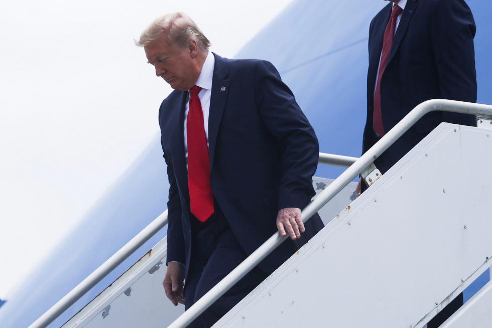 U.S. President Donald Trump walks down the steps of Air Force One as he arrives to attend the launch of SpaceX Falcon 9 rocket and Crew Dragon spacecraft from NASA's Kennedy Space Center in Cape Canaveral,