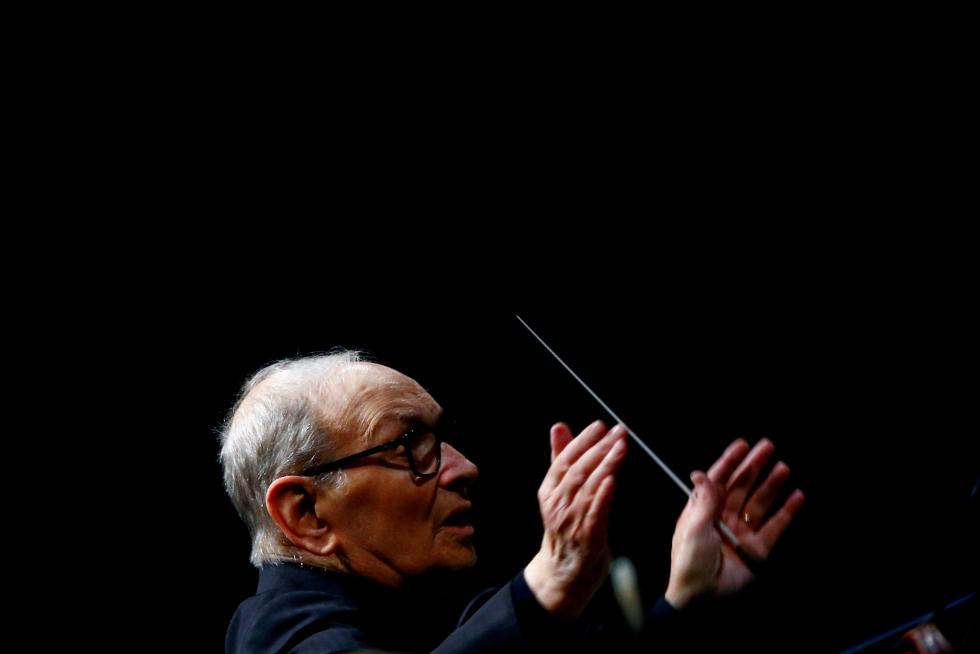FILE PHOTO: Italian composer Ennio Morricone conducts a concert in Berlin