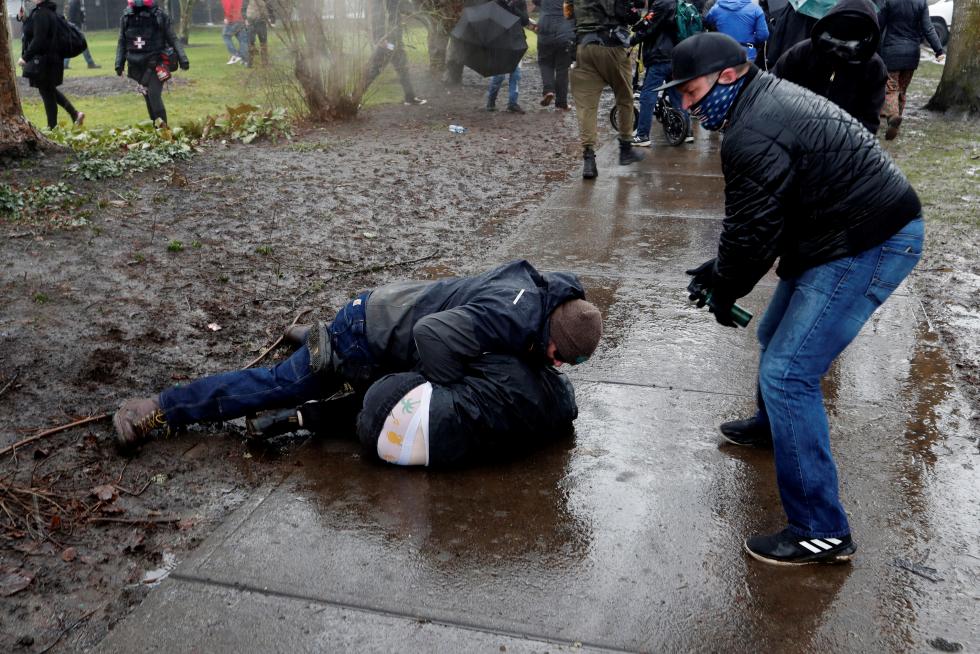Supporters of U.S. President Donald Trump fight with counter-demonstrators at a rally in support of Trump at the Oregon State Capitol in Salem