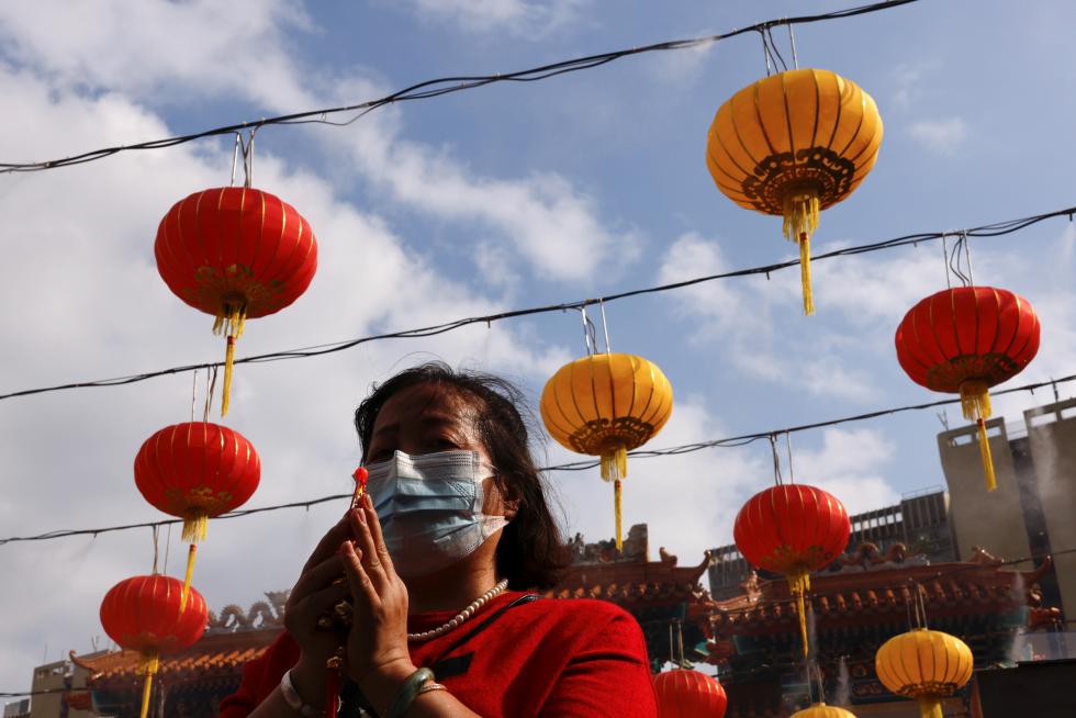 A worshipper wearing face mask prays at the first day of Chinese Lunar New Year, following the coronavirus disease (COVID-19) outbreak, at Wong Tai Sin Temple, in Hong Kong