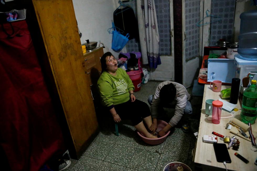 The Wider Image: 'I've let them down': Beijing's migrant workers miss family reunions on Lunar New Year