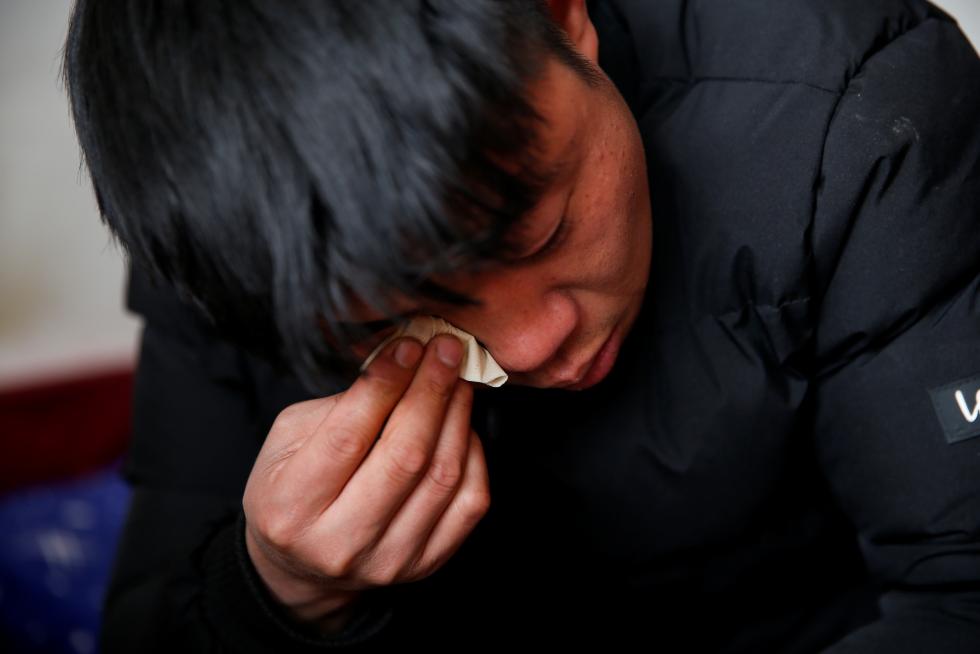 The Wider Image: 'I've let them down': Beijing's migrant workers miss family reunions on Lunar New Year