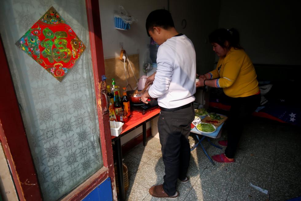 The Wider Image: 'I've let them down': Beijing's migrant workers miss family reunions on Lunar New Year