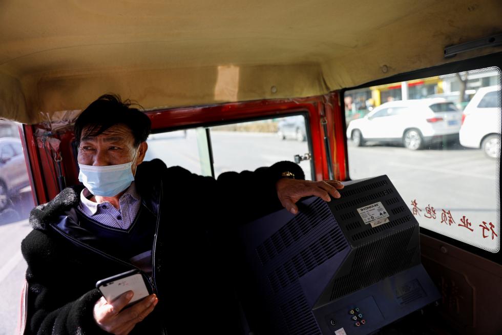 The Wider Image: 'I've let them down': Beijing's migrant workers miss family reunions on Lunar New Year
