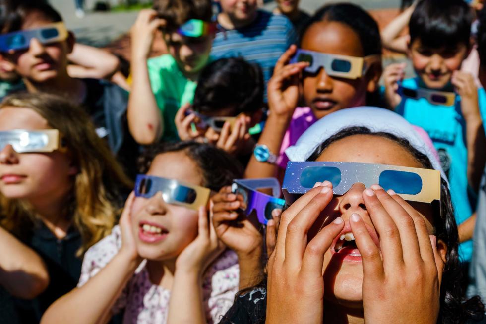 Students watch partial solar eclipse