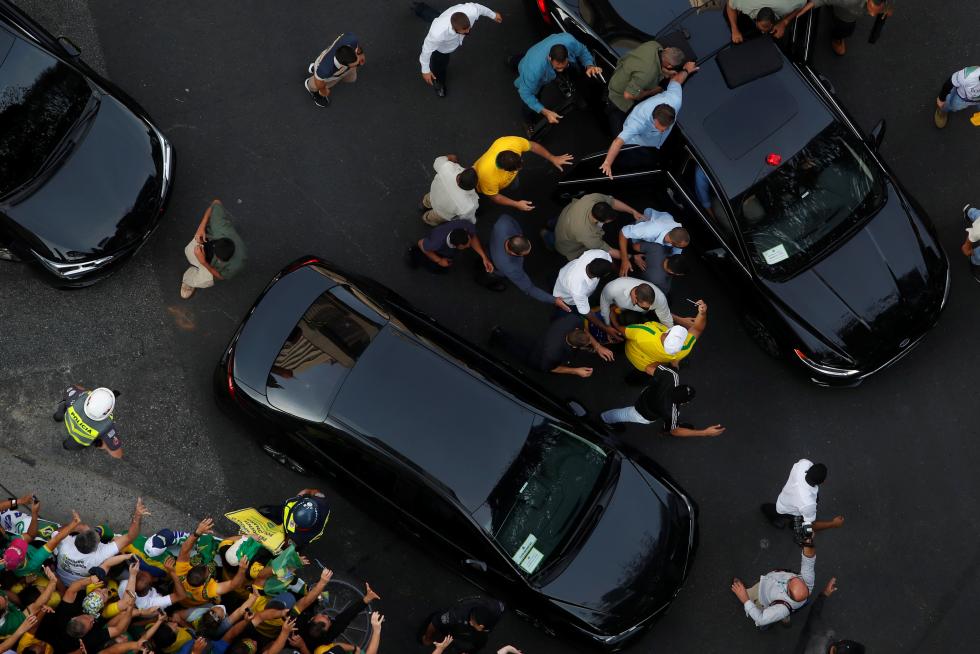 Brazilian President Jair Bolsonaro boards a car as his supporters gather to back the far-right leader in his dispute with the Supreme Court, in Sao Paulo