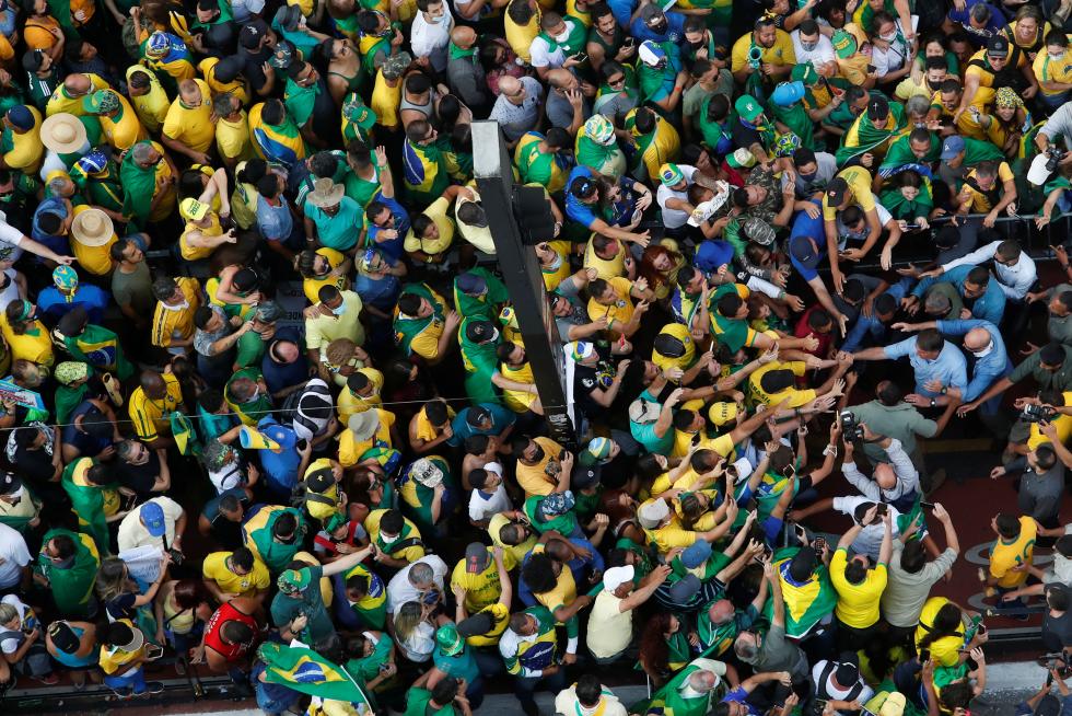 Brazilian President Jair Bolsonaro greets his supporters as they gather to back the far-right leader in his dispute with the Supreme Court, in Sao Paulo