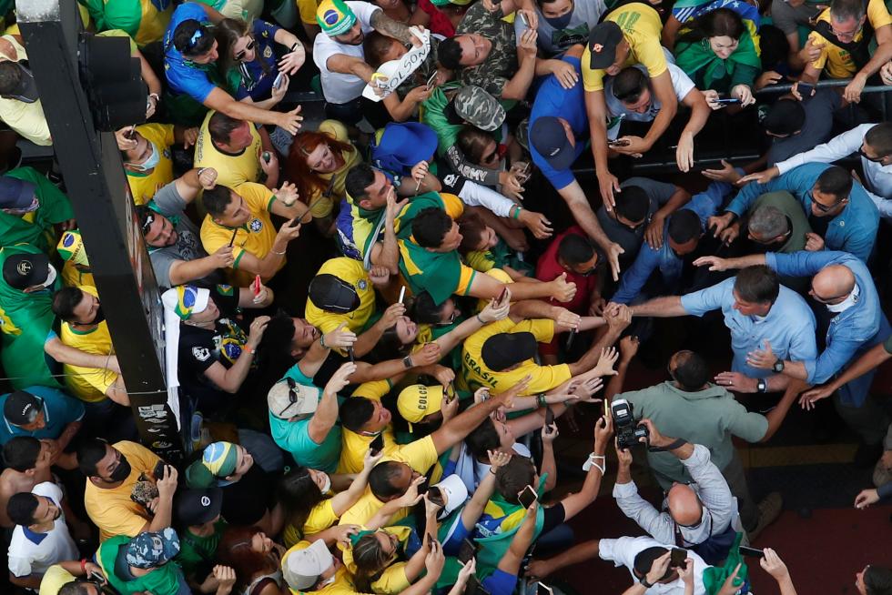 Brazilian President Jair Bolsonaro greets his supporters as they gather to back the far-right leader in his dispute with the Supreme Court, in Sao Paulo