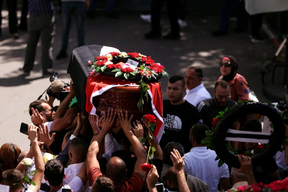 Family and friends of Al Jazeera reporter Shireen Abu Akleh, who was killed during an Israeli raid in Jenin in the occupied West Bank, carry her body as she arrives in Jerusalem, May 12, 2022. REUTERS/Ammar Awad PALESTINIANS-ISRAEL/JOURNALIST