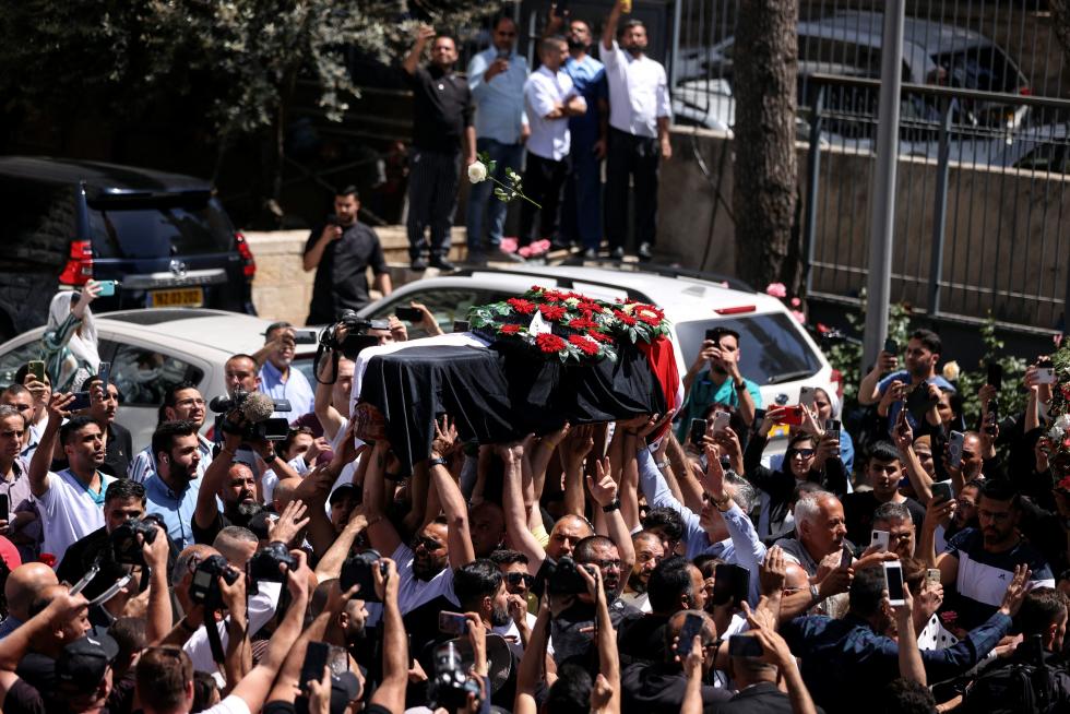 Family and friends of Al Jazeera reporter Shireen Abu Akleh, who was killed during an Israeli raid in Jenin in the occupied West Bank, carry her body as she arrives in Jerusalem, May 12, 2022. REUTERS/Ammar Awad PALESTINIANS-ISRAEL/JOURNALIST