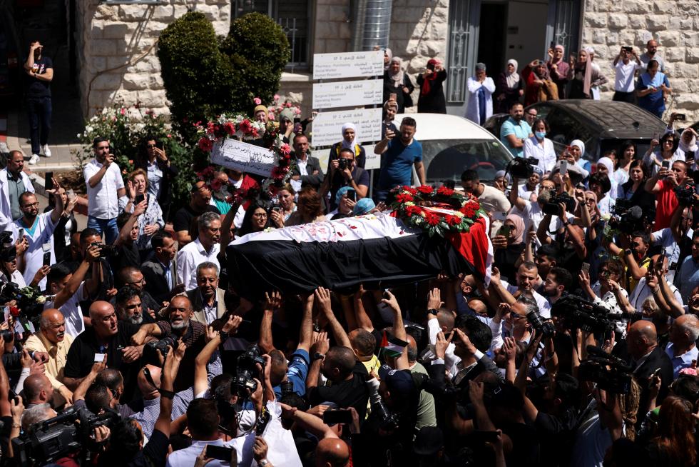 Family and friends of Al Jazeera reporter Shireen Abu Akleh, who was killed during an Israeli raid in Jenin in the occupied West Bank, carry her body as she arrives in Jerusalem, May 12, 2022. REUTERS/Ammar Awad PALESTINIANS-ISRAEL/JOURNALIST