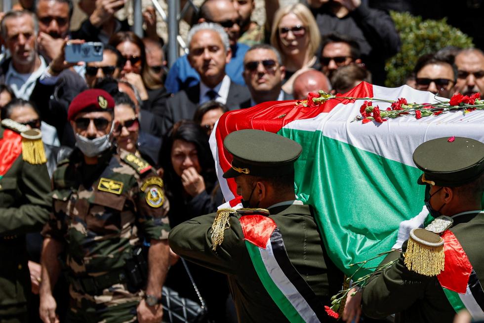 Family and friends of Al Jazeera reporter Shireen Abu Akleh, who was killed during an Israeli raid in Jenin in the occupied West Bank, carry her body as she arrives in Jerusalem, May 12, 2022. REUTERS/Ammar Awad PALESTINIANS-ISRAEL/JOURNALIST