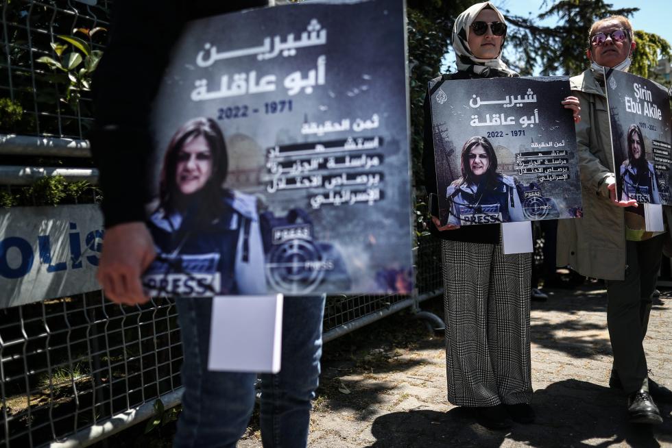 A protester carries a picture of Al Jazeera reporter Shireen Abu Akleh, who was killed during an Israeli raid in Jenin in the occupied West Bank, during a march rally against military rule following a coup in Khartoum, Sudan May 12, 2022. REUTERS/Mohamed Nureldin Abdallah SUDAN-POLITICS/