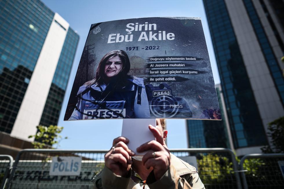 A protester carries a picture of Al Jazeera reporter Shireen Abu Akleh, who was killed during an Israeli raid in Jenin in the occupied West Bank, during a march rally against military rule following a coup in Khartoum, Sudan May 12, 2022. REUTERS/Mohamed Nureldin Abdallah SUDAN-POLITICS/