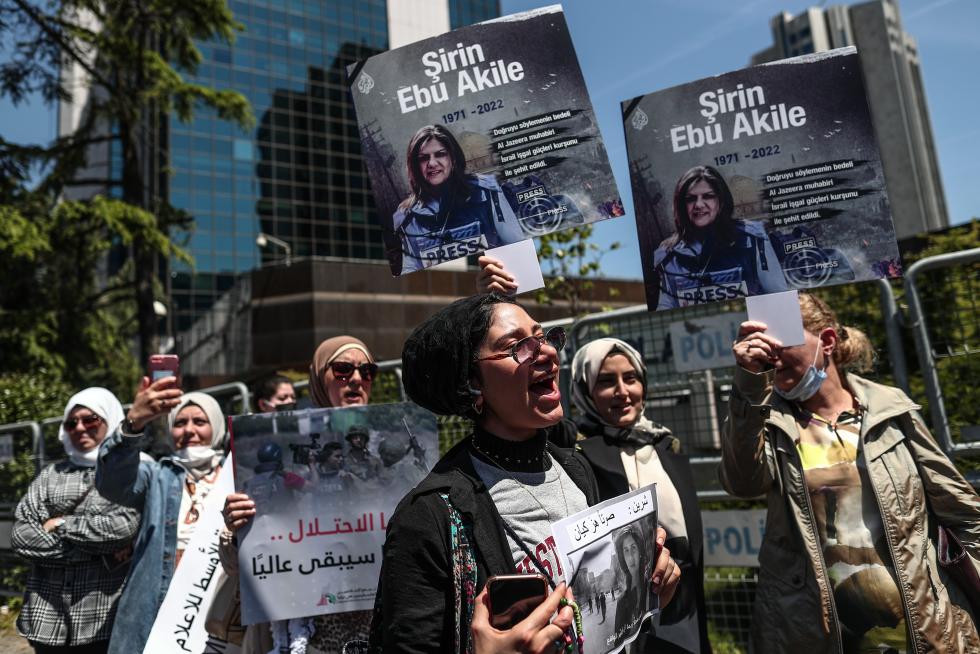 A protester carries a picture of Al Jazeera reporter Shireen Abu Akleh, who was killed during an Israeli raid in Jenin in the occupied West Bank, during a march rally against military rule following a coup in Khartoum, Sudan May 12, 2022. REUTERS/Mohamed Nureldin Abdallah SUDAN-POLITICS/