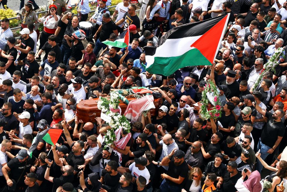 Family and friends carry the coffin of Al Jazeera reporter Shireen Abu Akleh, who was killed during an Israeli raid in Jenin in the occupied West Bank, as clashes erupted with Israeli security forces, during her funeral in Jerusalem, May 13, 2022. REUTERS/Ammar Awad ISRAEL-PALESTINIANS/JOURNALIST