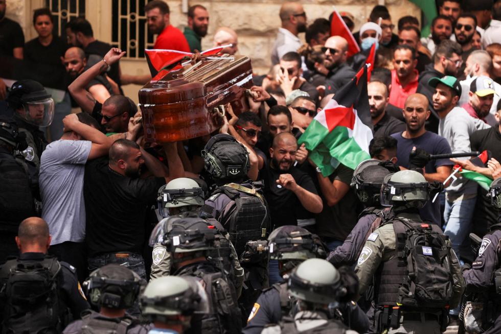 Family and friends carry the coffin of Al Jazeera reporter Shireen Abu Akleh, who was killed during an Israeli raid in Jenin in the occupied West Bank, during her funeral in Jerusalem, May 13, 2022. REUTERS/Ammar Awad ISRAEL-PALESTINIANS/JOURNALIST