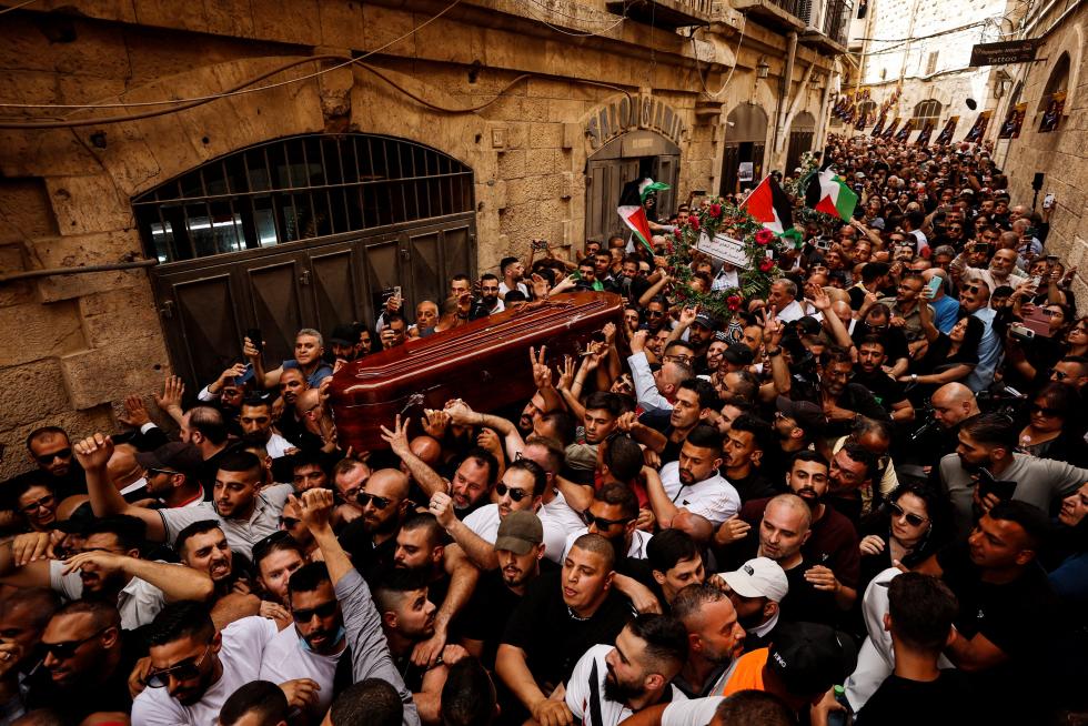 Family and friends carry the coffin of Al Jazeera reporter Shireen Abu Akleh, who was killed during an Israeli raid in Jenin in the occupied West Bank, during her funeral in Jerusalem, May 13, 2022. REUTERS/Ammar Awad ISRAEL-PALESTINIANS/JOURNALIST